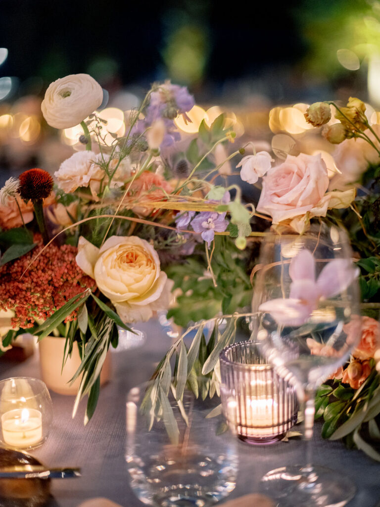 Lush floral table runner for fall wedding reception. Outdoor wedding reception at Southall Farm & Inn in Tennessee. Soft whimsical floral design for unique fall wedding design. Fall wedding color palette in brown, soft blue, dusty rose, and muted greens. Whimsical florals featuring dried hydrangeas, tulips, delphinium, and grasses. Design by Rosemary & Finch Floral Design in Nashville, TN. 