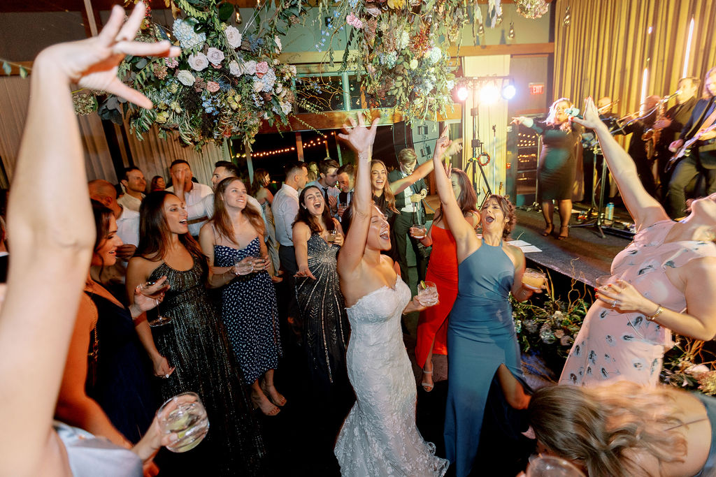 Epic floral clouds for reception dance floor. Floral clouds perfectly frame the stage for this fall wedding reception. Soft whimsical floral design for unique fall wedding design. Fall wedding color palette in brown, soft blue, dusty rose, and muted greens. Whimsical florals featuring dried hydrangeas, tulips, delphinium, and grasses. Design by Rosemary & Finch Floral Design in Nashville, TN.