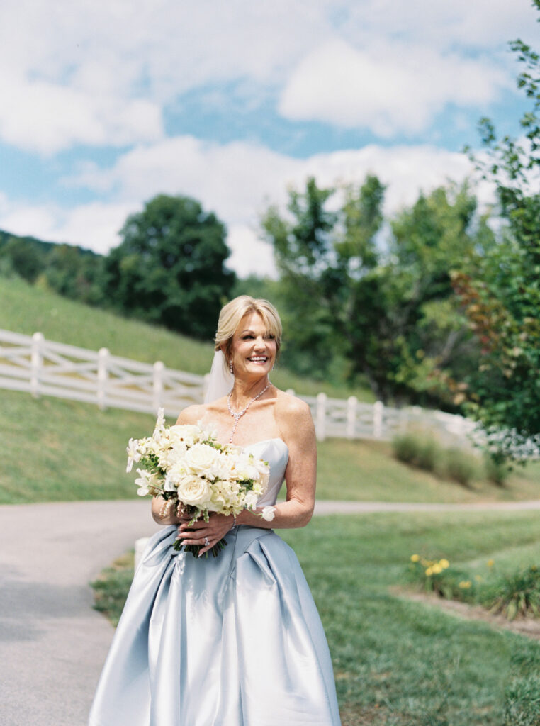 Bridal bouquet lush with floral moments in cream and blush tones. Petal heavy and whimsical floral design for bridal bouquet in fall wedding at Blackberry Farm. Garden inspired floral design with elegant design choices for fall wedding weekend. Unique bridal gown for wedding ceremony. Destination wedding at Blackberry Farm. Design by Rosemary & Finch Floral Design in Nashville, TN.