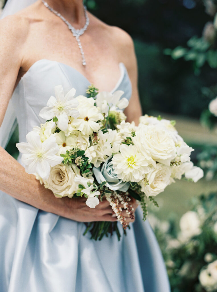 Bridal bouquet lush with floral moments in cream and blush tones. Petal heavy and whimsical floral design for bridal bouquet in fall wedding at Blackberry Farm. Garden inspired floral design with elegant design choices for fall wedding weekend. Unique bridal gown for wedding ceremony. Destination wedding at Blackberry Farm. Design by Rosemary & Finch Floral Design in Nashville, TN.