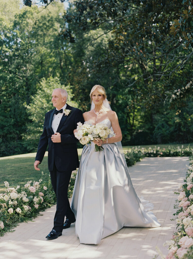 Bridal bouquet lush with floral moments in cream and blush tones. Petal heavy and whimsical floral design for bridal bouquet in fall wedding at Blackberry Farm. Garden inspired floral design with elegant design choices for fall wedding weekend. Unique bridal gown for wedding ceremony. Destination wedding at Blackberry Farm. Design by Rosemary & Finch Floral Design in Nashville, TN.