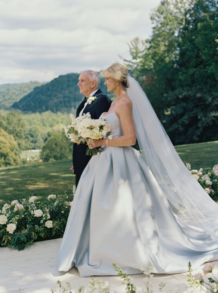 Bridal bouquet lush with floral moments in cream and blush tones. Petal heavy and whimsical floral design for bridal bouquet in fall wedding at Blackberry Farm. Garden inspired floral design with elegant design choices for fall wedding weekend. Unique bridal gown for wedding ceremony. Destination wedding at Blackberry Farm. Design by Rosemary & Finch Floral Design in Nashville, TN.