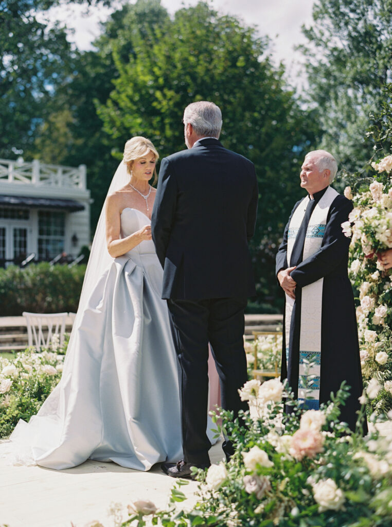 Epic ceremony backdrop for fall wedding at Blackberry Farms. Lush broken arch floral design for wedding ceremony backdrop. Garden inspired growing floral in colors of cream, white, blush, and green. Full coverage floral aisle for wedding ceremony. Floral meadows with petal heavy roses. Floral heavy flora design with elegant and whimsical design. Destination wedding at Blackberry Farm. Design by Rosemary & Finch Floral Design in Nashville, TN. 