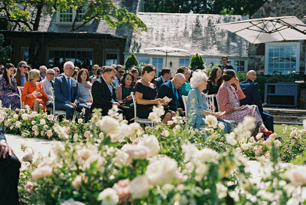 Epic ceremony backdrop for fall wedding at Blackberry Farms. Lush broken arch floral design for wedding ceremony backdrop. Garden inspired growing floral in colors of cream, white, blush, and green. Full coverage floral aisle for wedding ceremony. Floral meadows with petal heavy roses. Floral heavy flora design with elegant and whimsical design. Destination wedding at Blackberry Farm. Design by Rosemary & Finch Floral Design in Nashville, TN. 