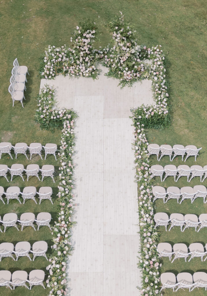 Epic ceremony backdrop for fall wedding at Blackberry Farms. Lush broken arch floral design for wedding ceremony backdrop. Garden inspired growing floral in colors of cream, white, blush, and green. Full coverage floral aisle for wedding ceremony. Floral meadows with petal heavy roses. Floral heavy flora design with elegant and whimsical design. Destination wedding at Blackberry Farm. Design by Rosemary & Finch Floral Design in Nashville, TN. 