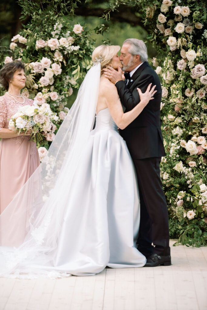 Epic ceremony backdrop for fall wedding at Blackberry Farms. Lush broken arch floral design for wedding ceremony backdrop. Garden inspired growing floral in colors of cream, white, blush, and green. Full coverage floral aisle for wedding ceremony. Floral meadows with petal heavy roses. Floral heavy flora design with elegant and whimsical design. Destination wedding at Blackberry Farm. Design by Rosemary & Finch Floral Design in Nashville, TN. 