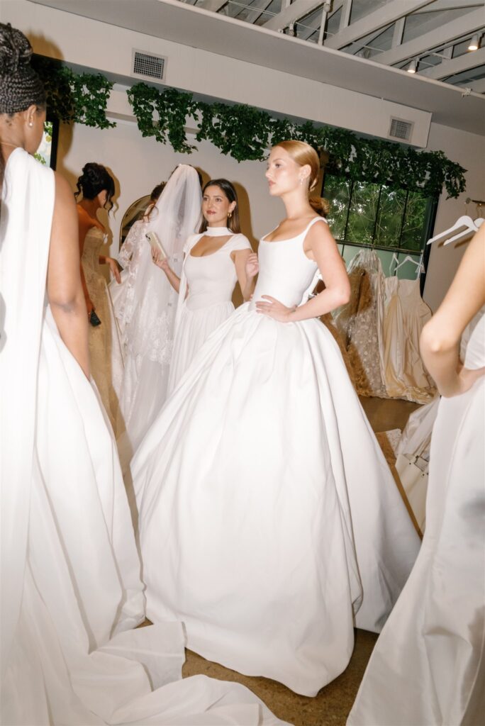 Garden-inspired, whimsical arrangements for bridal fashion show in Nashville, TN. Floral arrangements feature texture and movement, with Queen Anne’s lace, oncidium orchids, blue nigella, lisianthus, zinnias, amaranthus, allium, coneflower, smokebush, forget me nots and airy grasses. With earthy greens, soft whites, golden yellow, mauve and burgundy, the flowers showcase a meadow-like focal point for a fashion runway. Design by Rosemary & Finch Floral Design in Nashville, TN.