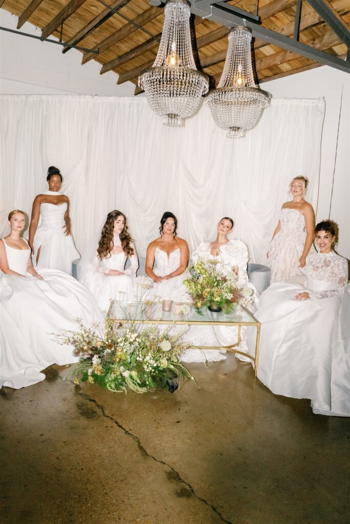 Lush, garden-inspired florals for summer bridal fashion show in Nashville, TN. Textured floral arrangements consist of Queen Anne’s lace, oncidium orchids, blue nigella, lisianthus, zinnias, amaranthus, allium, coneflower, smokebush, forget me nots, ferns and airy grasses. With earthy greens, soft whites, yellows, mauve and burgundy, the flowers spill out and showcase a modern and editorial focal point for bridal portraits. Design by Rosemary & Finch Floral Design in Nashville, TN.