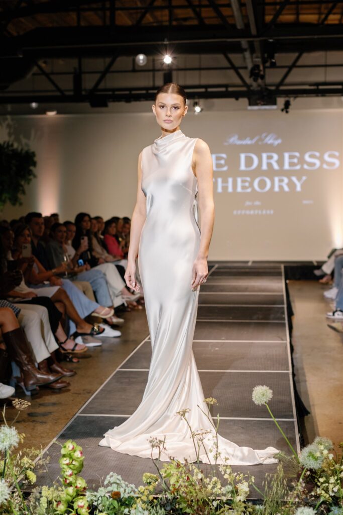 Lush, garden-inspired bar arrangement for bridal fashion show in Nashville, TN. The bar statement features texture and movement, with Queen Anne’s lace, oncidium orchids, blue nigella, lisianthus, zinnias, coneflower, smokebush, forget me nots and airy grasses. With earthy greens, soft whites, golden yellow, mauve and burgundy, the flowers create a whimsical, meadow-like focal point for a modern bar. Design by Rosemary & Finch Floral Design in Nashville, TN.