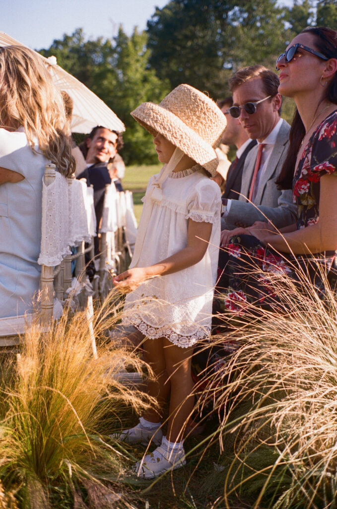 Elegant, organic and untamed outdoor wedding ceremony at Blackberry Farms featured in Vogue. Whimsical, grassy meadows line the aisle and floral accents are highlighted with white cosmos, green mist, solidago, yarrow, scabiosa and grasses. Pergola is covered in lush greenery with soft touches of cream roses and wispy meadows at the base. Design by Rosemary & Finch Floral Design in Nashville, TN. 