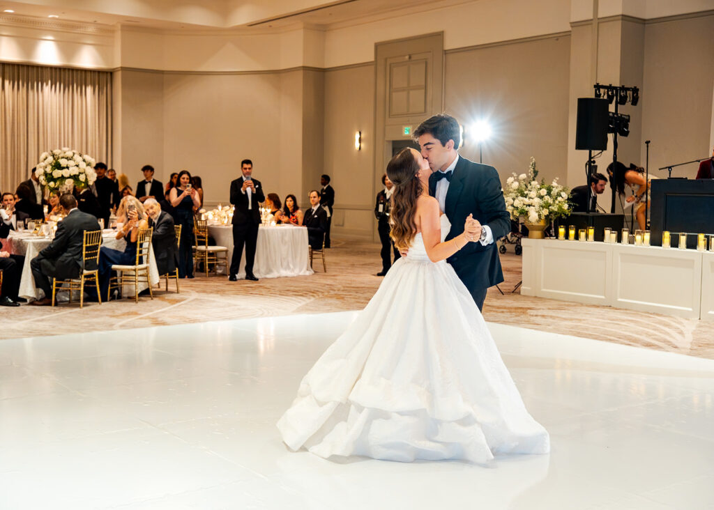Stunning reception florals for summer wedding reception in Buckhead, Atlanta. All-white floral centerpieces featuring cloud roses, playa blanca roses, peonies, ranunculus, double tulips and lisianthus. Minimal greenery complements beautiful floral table arrangements and bud vases. Elevated all-white rose centerpieces scattered throughout reception. Design by Rosemary & Finch Floral Design in Nashville, TN.
