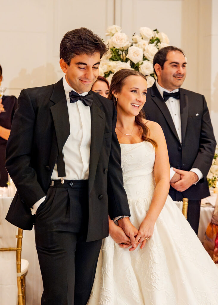Stunning reception florals for summer wedding reception in Buckhead, Atlanta. All-white floral centerpieces featuring cloud roses, playa blanca roses, peonies, ranunculus, double tulips and lisianthus. Minimal greenery complements beautiful floral table arrangements and bud vases. Elevated all-white rose centerpieces scattered throughout reception. Design by Rosemary & Finch Floral Design in Nashville, TN.