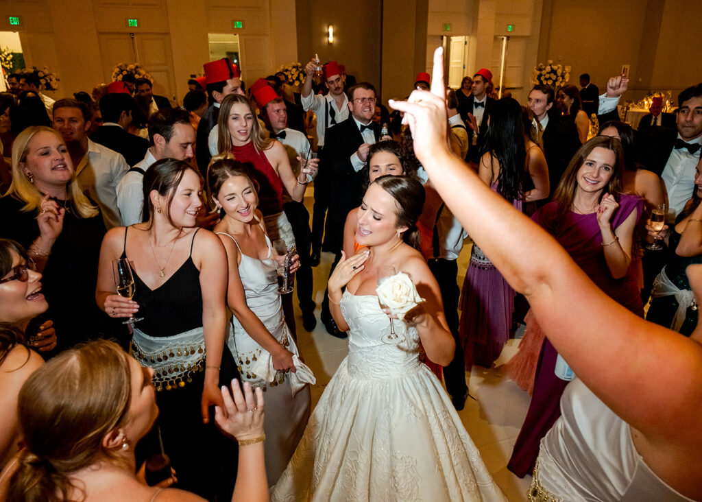 Stunning reception florals for summer wedding reception in Buckhead, Atlanta. All-white floral centerpieces featuring cloud roses, playa blanca roses, peonies, ranunculus, double tulips and lisianthus. Minimal greenery complements beautiful floral table arrangements and bud vases. Elevated all-white rose centerpieces scattered throughout reception. Design by Rosemary & Finch Floral Design in Nashville, TN.