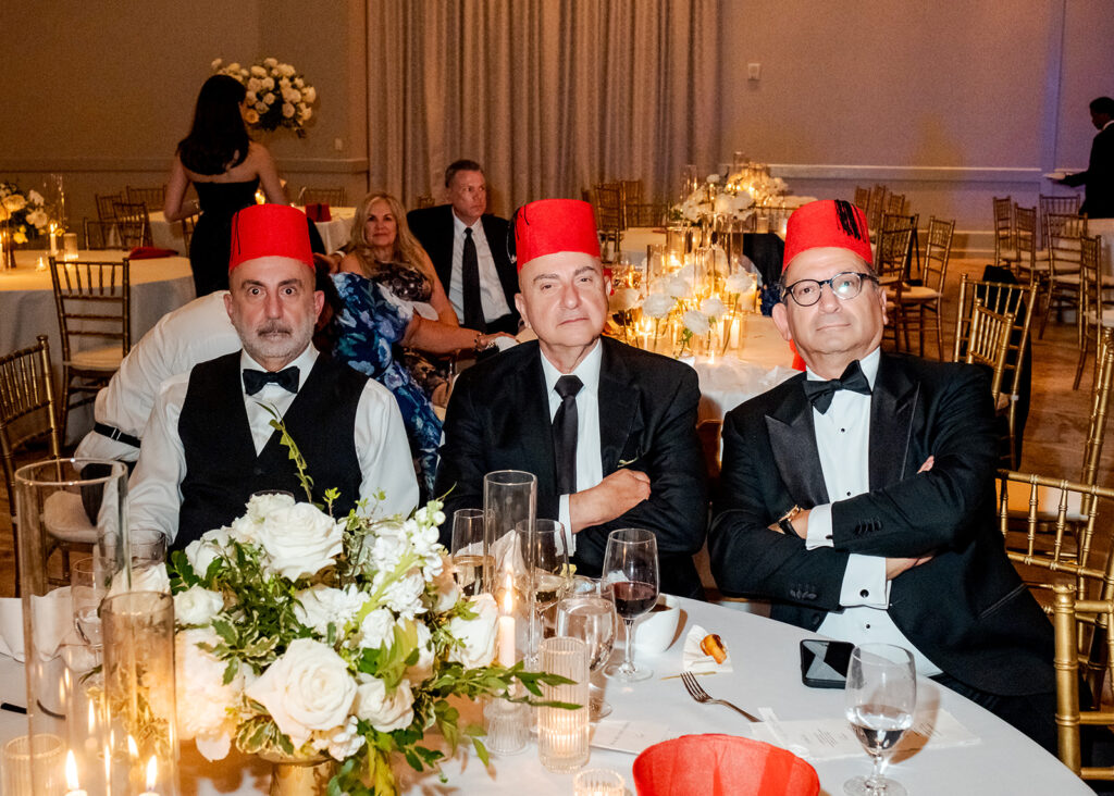 Stunning reception florals for summer wedding reception in Buckhead, Atlanta. All-white floral centerpieces featuring cloud roses, playa blanca roses, peonies, ranunculus, double tulips and lisianthus. Minimal greenery complements beautiful floral table arrangements and bud vases. Elevated all-white rose centerpieces scattered throughout reception. Design by Rosemary & Finch Floral Design in Nashville, TN.