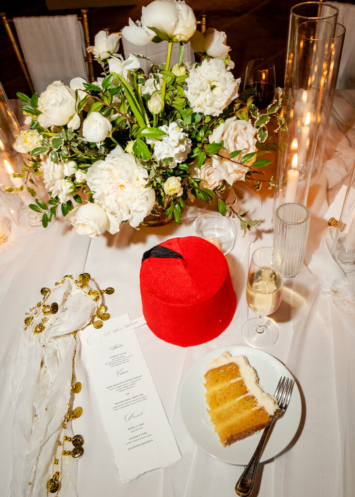 Stunning reception florals for summer wedding reception in Buckhead, Atlanta. All-white floral centerpieces featuring cloud roses, playa blanca roses, peonies, ranunculus, double tulips and lisianthus. Minimal greenery complements beautiful floral table arrangements and bud vases. Elevated all-white rose centerpieces scattered throughout reception. Design by Rosemary & Finch Floral Design in Nashville, TN.