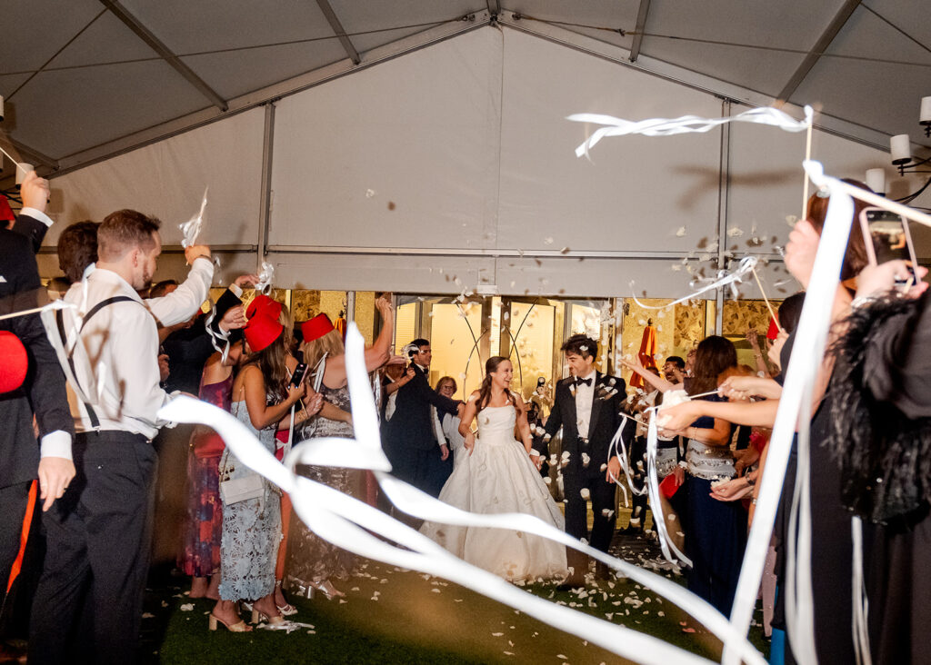 Stunning reception florals for summer wedding reception in Buckhead, Atlanta. All-white floral centerpieces featuring cloud roses, playa blanca roses, peonies, ranunculus, double tulips and lisianthus. Minimal greenery complements beautiful floral table arrangements and bud vases. Elevated all-white rose centerpieces scattered throughout reception. Design by Rosemary & Finch Floral Design in Nashville, TN.
