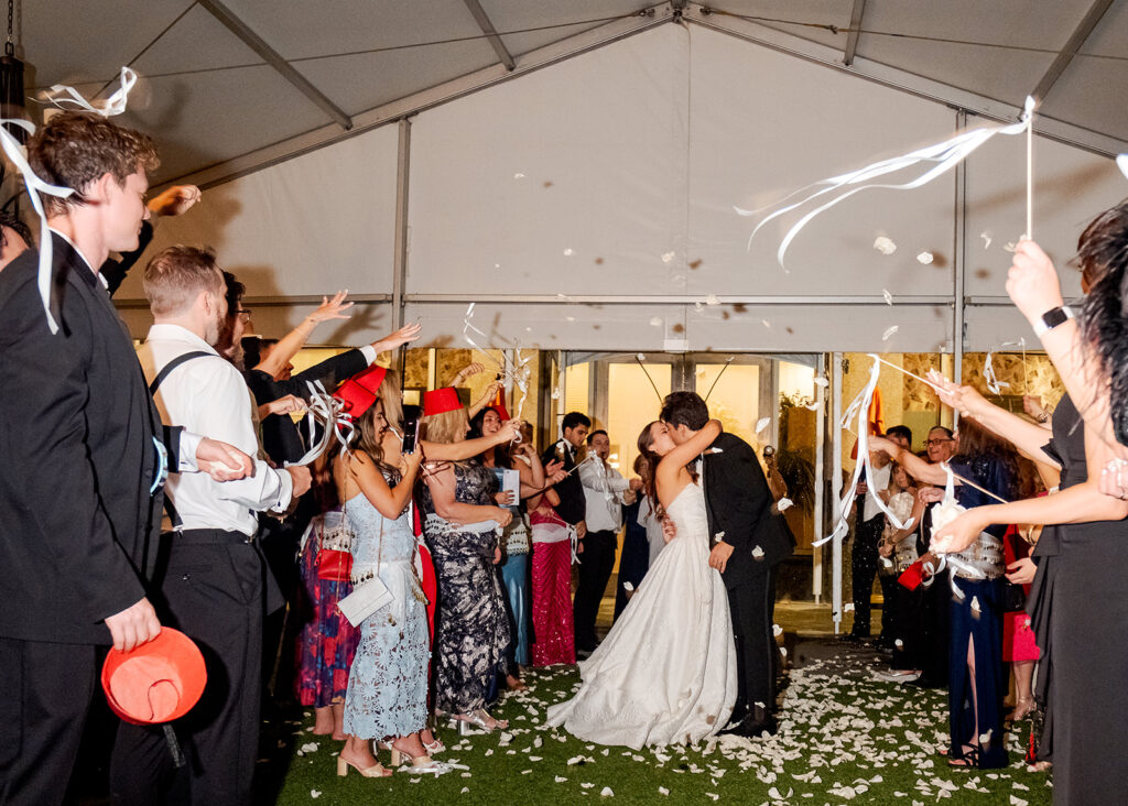 Stunning reception florals for summer wedding reception in Buckhead, Atlanta. All-white floral centerpieces featuring cloud roses, playa blanca roses, peonies, ranunculus, double tulips and lisianthus. Minimal greenery complements beautiful floral table arrangements and bud vases. Elevated all-white rose centerpieces scattered throughout reception. Design by Rosemary & Finch Floral Design in Nashville, TN.