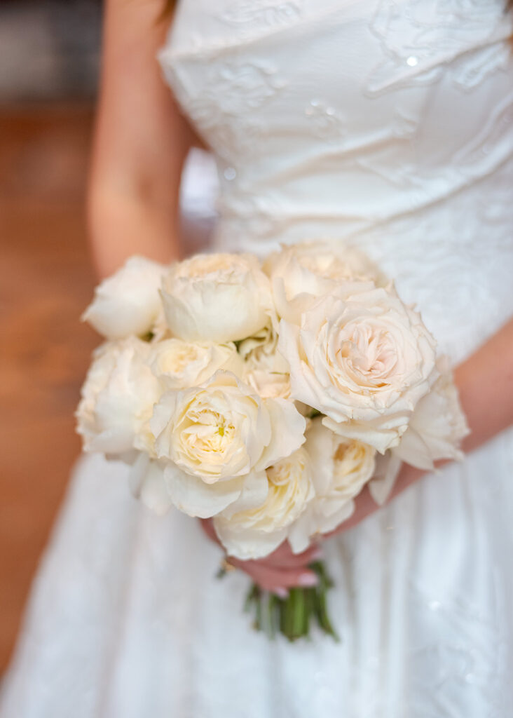 Editorial, modern bridal bouquet with white playa blanca and cloud garden roses and white peonies. Soft, romantic and timeless floral design for Atlanta wedding in Buckhead. Elegant, all-white wedding flowers in a luxury setting. Design by Rosemary & Finch Floral Design in Nashville, TN.