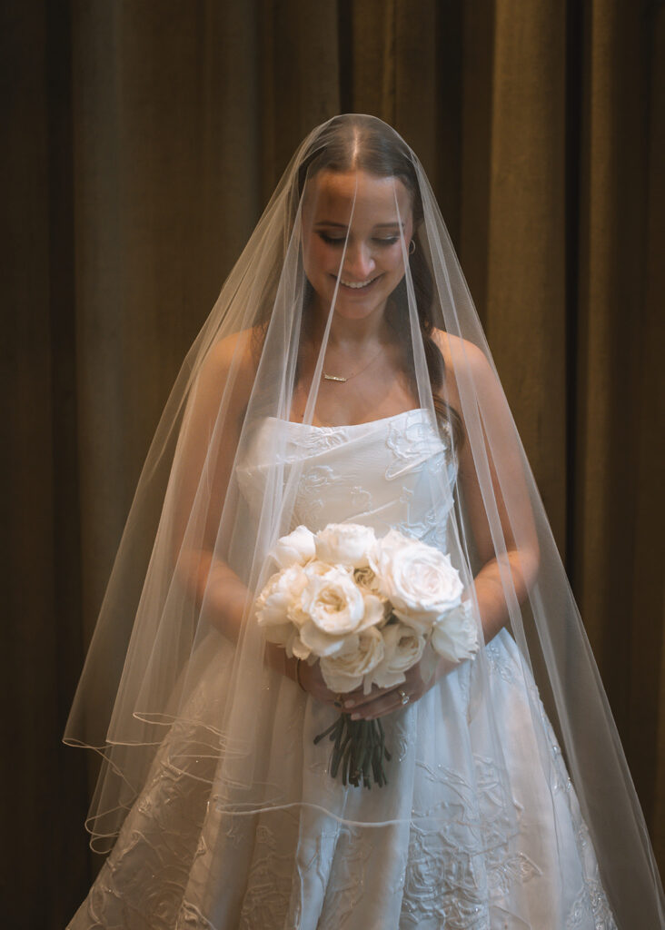 Editorial, modern bridal bouquet with white playa blanca and cloud garden roses and white peonies. Soft, romantic and timeless floral design for Atlanta wedding in Buckhead. Elegant, all-white wedding flowers in a luxury setting. Design by Rosemary & Finch Floral Design in Nashville, TN.