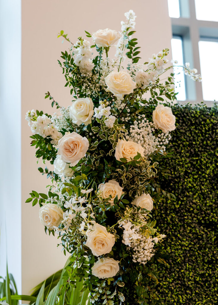 Stunning cocktail hour florals for wedding reception in Buckhead, Atlanta. All-white florals featuring cloud roses, playa blanca roses, peonies, ranunculus, delphinium, baby’s breath, double tulips and lisianthus. Soft and romantic floral display for summer wedding. Design by Rosemary & Finch Floral Design in Nashville, TN.