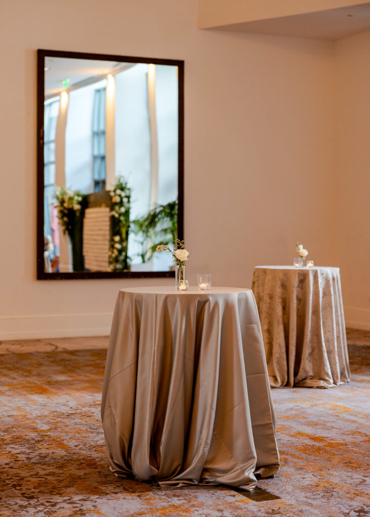 Stunning cocktail hour florals for wedding reception in Buckhead, Atlanta. All-white florals featuring cloud roses, playa blanca roses, peonies, ranunculus, delphinium, baby’s breath, double tulips and lisianthus. Soft and romantic floral display for summer wedding. Design by Rosemary & Finch Floral Design in Nashville, TN.