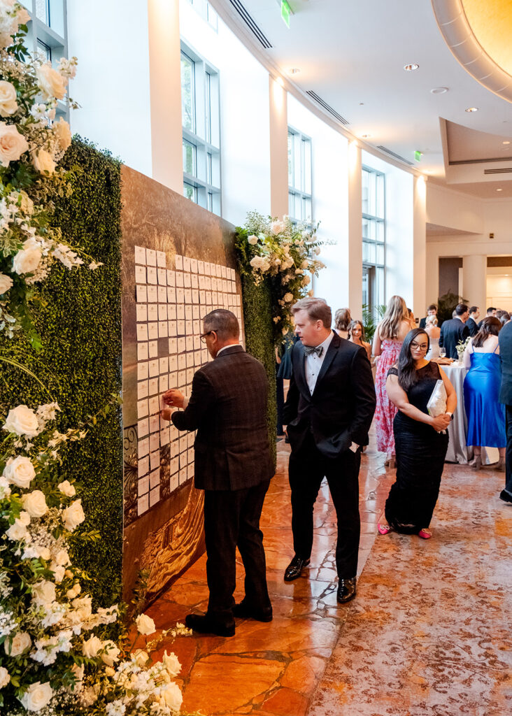 Stunning cocktail hour florals for wedding reception in Buckhead, Atlanta. All-white florals featuring cloud roses, playa blanca roses, peonies, ranunculus, delphinium, baby’s breath, double tulips and lisianthus. Soft and romantic floral display for summer wedding. Design by Rosemary & Finch Floral Design in Nashville, TN.