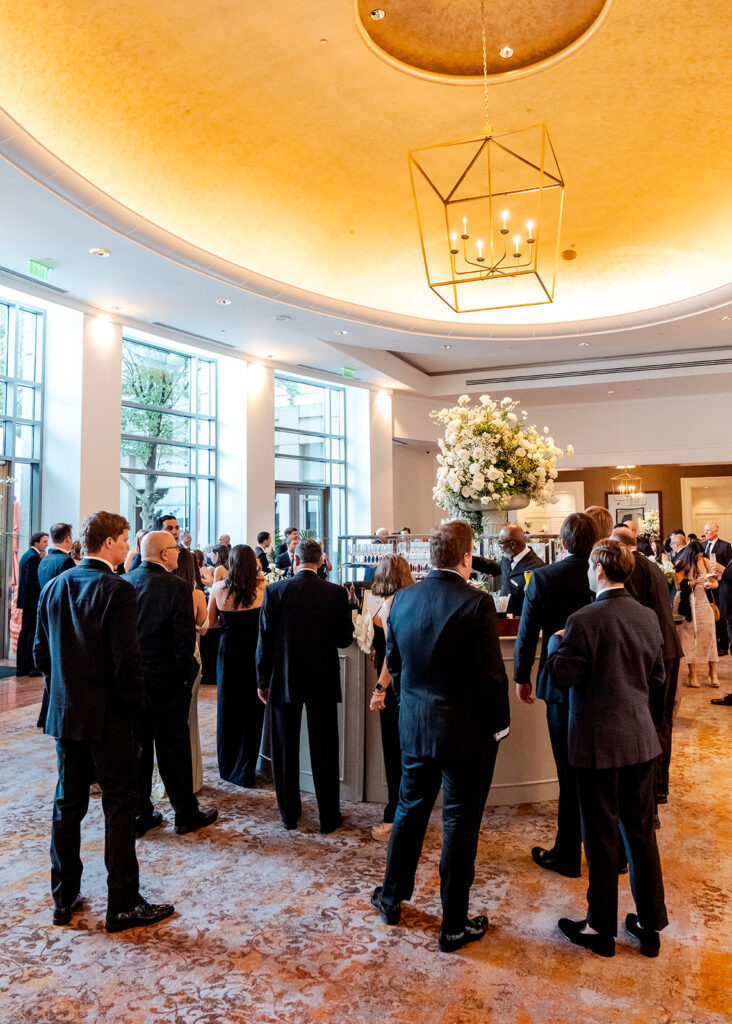 Stunning cocktail hour florals for wedding reception in Buckhead, Atlanta. All-white florals featuring cloud roses, playa blanca roses, peonies, ranunculus, delphinium, baby’s breath, double tulips and lisianthus. Soft and romantic floral display for summer wedding. Design by Rosemary & Finch Floral Design in Nashville, TN.