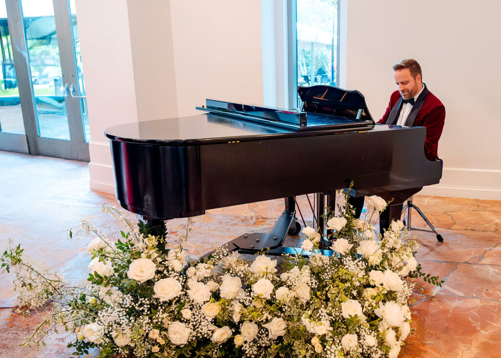 Stunning cocktail hour florals for wedding reception in Buckhead, Atlanta. All-white florals featuring cloud roses, playa blanca roses, peonies, ranunculus, delphinium, baby’s breath, double tulips and lisianthus. Soft and romantic floral display for summer wedding. Design by Rosemary & Finch Floral Design in Nashville, TN.