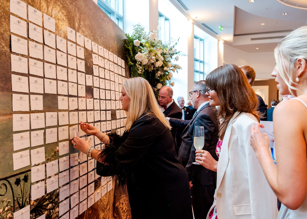 Stunning cocktail hour florals for wedding reception in Buckhead, Atlanta. All-white florals featuring cloud roses, playa blanca roses, peonies, ranunculus, delphinium, baby’s breath, double tulips and lisianthus. Soft and romantic floral display for summer wedding. Design by Rosemary & Finch Floral Design in Nashville, TN.