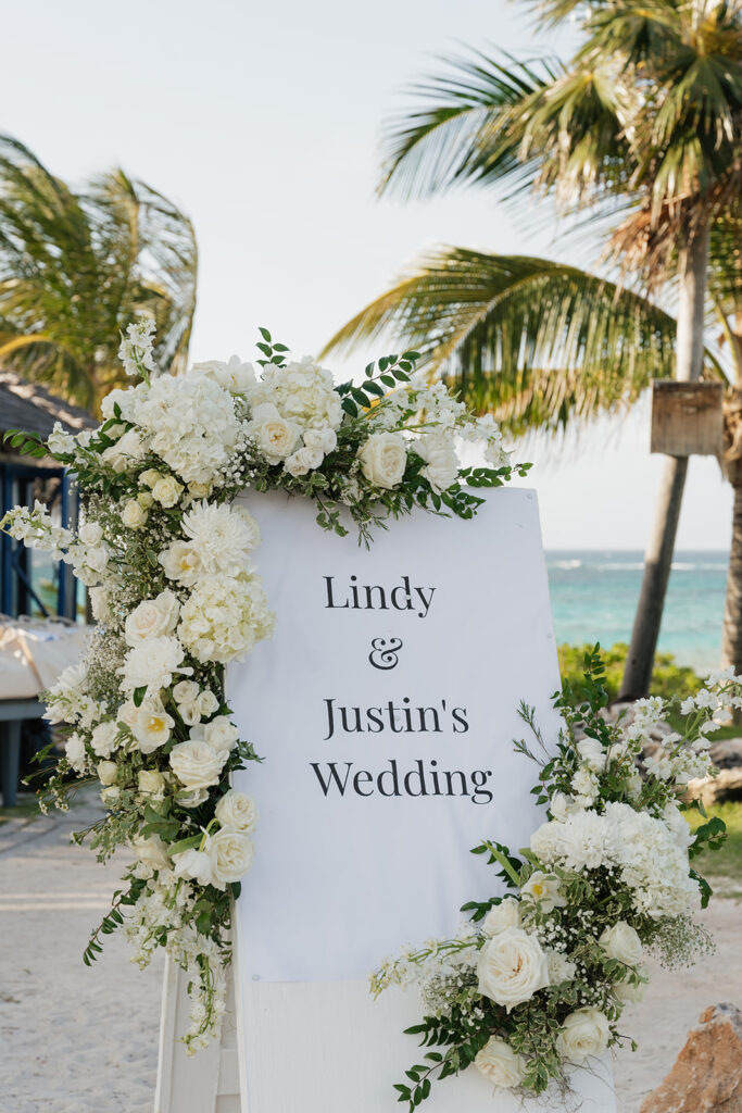 Simple, elegant arrangements for a beachfront wedding welcome party in the Bahamas. Romantic all-white florals create a timeless look highlighted with roses, hydrangeas, tulips, ranunculus, delphinium and greens. Design by Rosemary and Finch Floral Design in Nashville, TN.