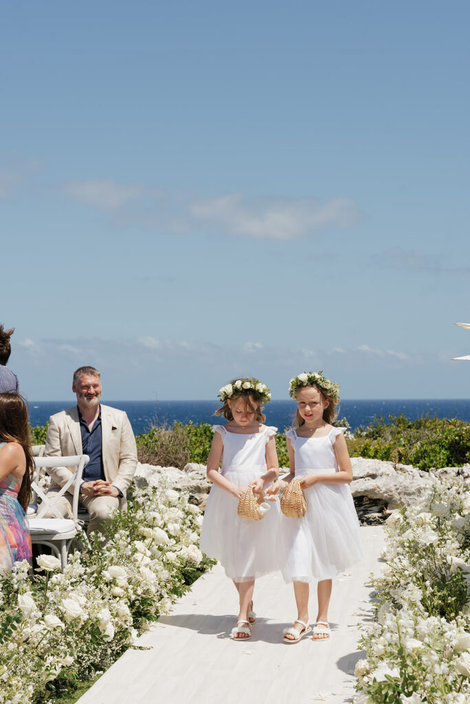 Lush, editorial bridal bouquet featuring all-white garden roses, ranunculus, delphinium, waxflower, oncidium, lisianthus, jasmine, sweet peas, tulips, clematis and a small mix of greenery. A slight hue of butter yellow is featured as well. Soft and romantic bouquet to highlight the airiness of a beachfront wedding in the Bahamas. Design by Rosemary & Finch Floral Design in Nashville, TN. 