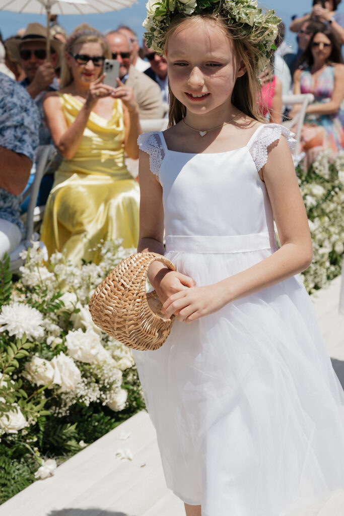 Lush, editorial bridal bouquet featuring all-white garden roses, ranunculus, delphinium, waxflower, oncidium, lisianthus, jasmine, sweet peas, tulips, clematis and a small mix of greenery. A slight hue of butter yellow is featured as well. Soft and romantic bouquet to highlight the airiness of a beachfront wedding in the Bahamas. Design by Rosemary & Finch Floral Design in Nashville, TN. 