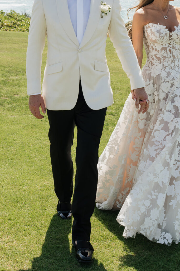 Lush, editorial bridal bouquet featuring all-white garden roses, ranunculus, delphinium, waxflower, oncidium, lisianthus, jasmine, sweet peas, tulips, clematis and a small mix of greenery. A slight hue of butter yellow is featured as well. Soft and romantic bouquet to highlight the airiness of a beachfront wedding in the Bahamas. Design by Rosemary & Finch Floral Design in Nashville, TN. 