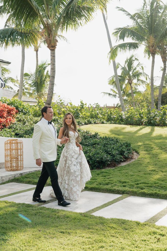 Lush, editorial bridal bouquet featuring all-white garden roses, ranunculus, delphinium, waxflower, oncidium, lisianthus, jasmine, sweet peas, tulips, clematis and a small mix of greenery. A slight hue of butter yellow is featured as well. Soft and romantic bouquet to highlight the airiness of a beachfront wedding in the Bahamas. Design by Rosemary & Finch Floral Design in Nashville, TN. 