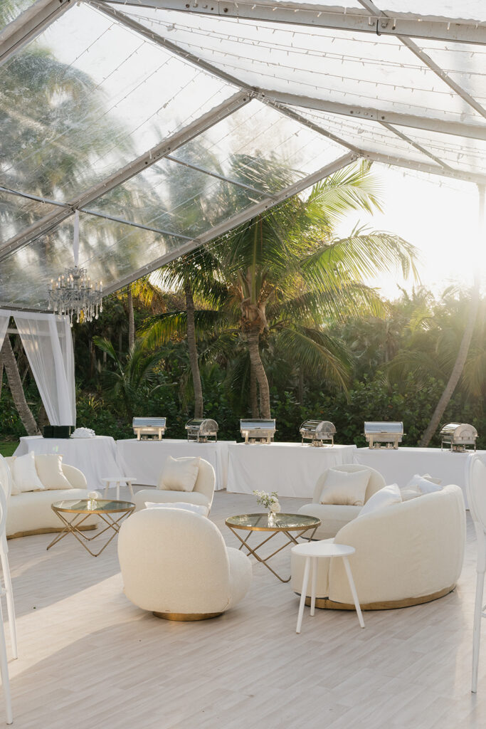 Simple, romantic all white floral bud vase arrangements for stunning bahamas cocktail hour. Bud vases are accompanied by all-white statement piece arrangements featuring garden roses, hydrangeas, spray roses, waxflower, delphinium, ranunculus, tulips, oncidium orchids, lisianthus, tweedia, lilac, sweet peas and are accented by a mix of greenery. Design by Rosemary & Finch Floral Design in Nashville, TN. 
