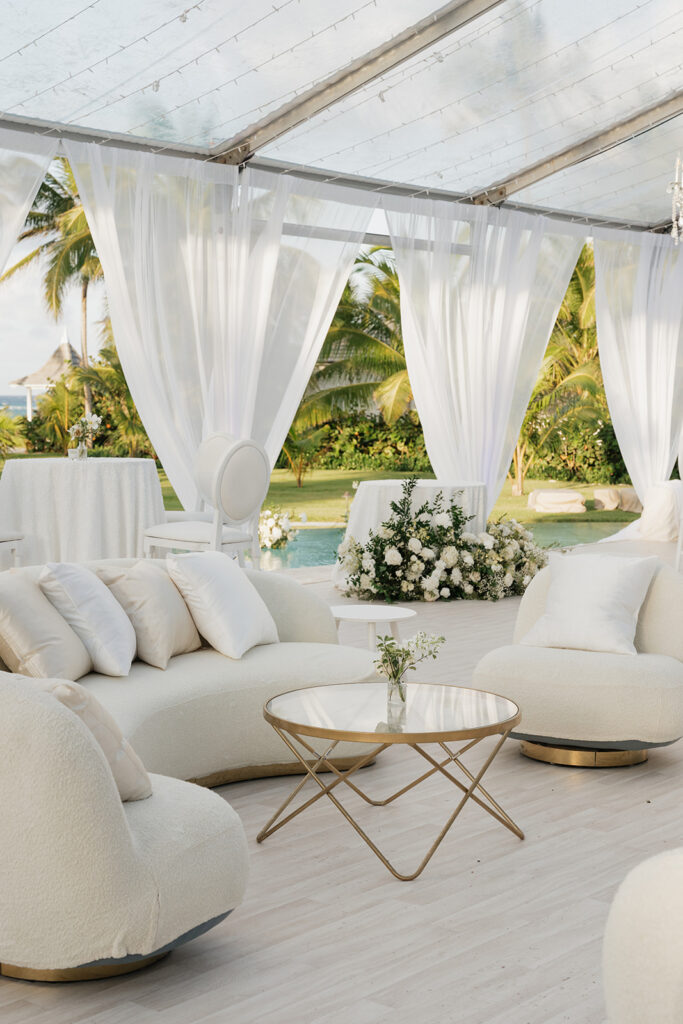 Simple, romantic all white floral bud vase arrangements for stunning bahamas cocktail hour. Bud vases are accompanied by all-white statement piece arrangements featuring garden roses, hydrangeas, spray roses, waxflower, delphinium, ranunculus, tulips, oncidium orchids, lisianthus, tweedia, lilac, sweet peas and are accented by a mix of greenery. Design by Rosemary & Finch Floral Design in Nashville, TN. 
