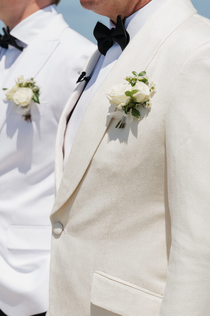 Lush, editorial bridal bouquet featuring all-white garden roses, ranunculus, delphinium, waxflower, oncidium, lisianthus, jasmine, sweet peas, tulips, clematis and a small mix of greenery. A slight hue of butter yellow is featured as well. Soft and romantic bouquet to highlight the airiness of a beachfront wedding in the Bahamas. Design by Rosemary & Finch Floral Design in Nashville, TN. 