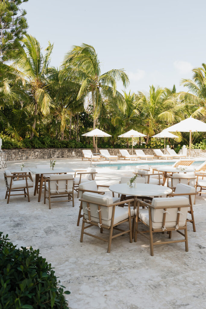 Simple, romantic all white floral bud vase arrangements for stunning bahamas cocktail hour. Bud vases are accompanied by all-white statement piece arrangements featuring garden roses, hydrangeas, spray roses, waxflower, delphinium, ranunculus, tulips, oncidium orchids, lisianthus, tweedia, lilac, sweet peas and are accented by a mix of greenery. Design by Rosemary & Finch Floral Design in Nashville, TN. 
