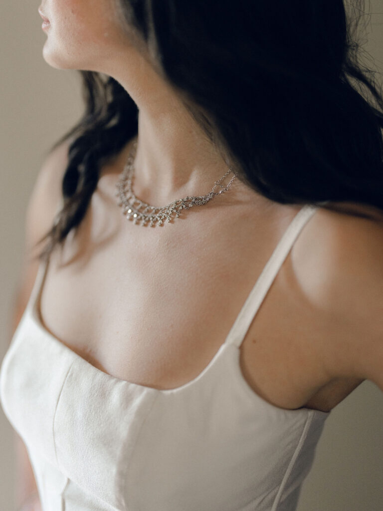 An autumnal, simple bridal bouquet displaying colors of burgundy, blush, rusty orange, and peach. Stunning florals include dahlias, garden roses, moab roses, cappuccino roses, brown ranunculus, zinnias, chocolate cosmos, brown sweet peas, toffee lisianthus, yarrow, marigolds and amaranthus. Beautiful fall florals for a wedding at Southall, TN. Design by Rosemary and Finch Floral Design in Nashville, TN.