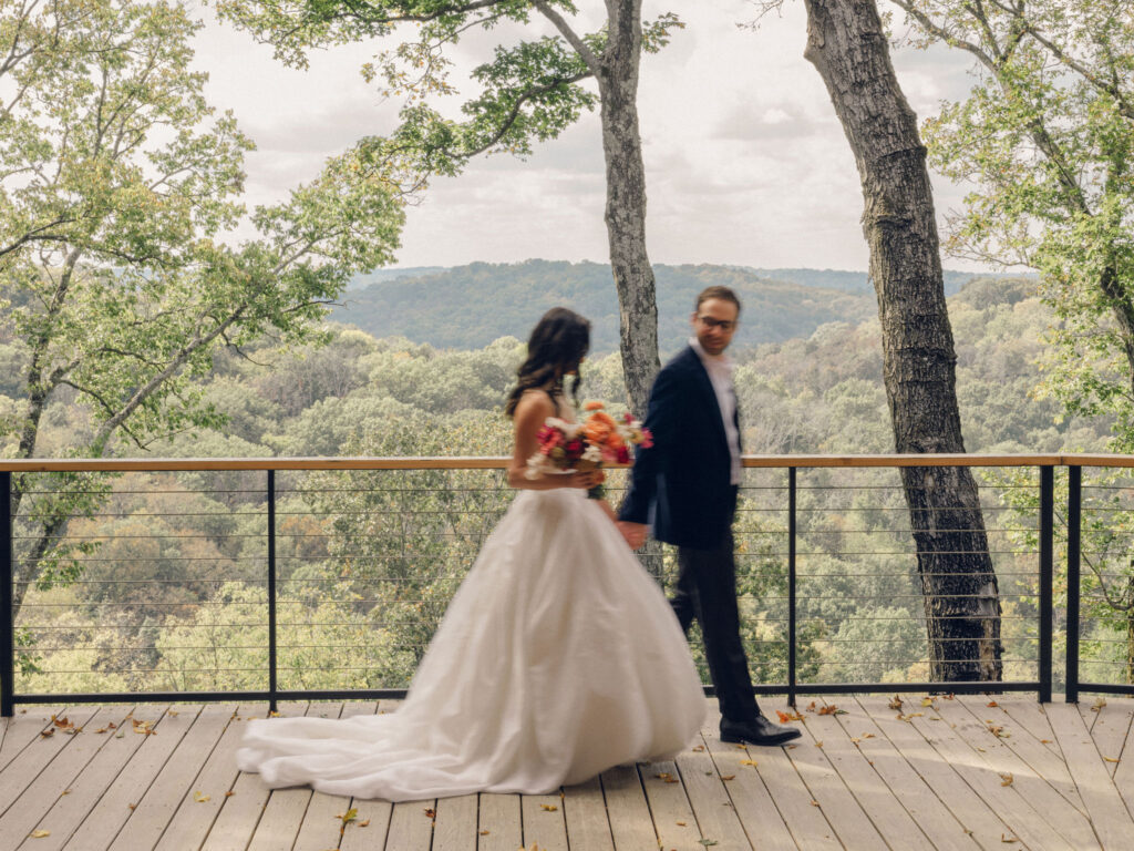 An autumnal, simple bridal bouquet displaying colors of burgundy, blush, rusty orange, and peach. Stunning florals include dahlias, garden roses, moab roses, cappuccino roses, brown ranunculus, zinnias, chocolate cosmos, brown sweet peas, toffee lisianthus, yarrow, marigolds and amaranthus. Beautiful fall florals for a wedding at Southall, TN. Design by Rosemary and Finch Floral Design in Nashville, TN.