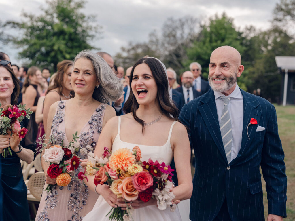 An autumnal, simple bridal bouquet displaying colors of burgundy, blush, rusty orange, and peach. Stunning florals include dahlias, garden roses, moab roses, cappuccino roses, brown ranunculus, zinnias, chocolate cosmos, brown sweet peas, toffee lisianthus, yarrow, marigolds and amaranthus. Beautiful fall florals for a wedding at Southall, TN. Design by Rosemary and Finch Floral Design in Nashville, TN.