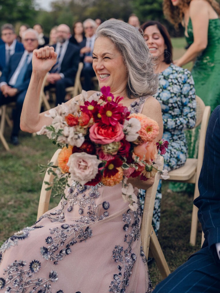 An autumnal, simple bridal bouquet displaying colors of burgundy, blush, rusty orange, and peach. Stunning florals include dahlias, garden roses, moab roses, cappuccino roses, brown ranunculus, zinnias, chocolate cosmos, brown sweet peas, toffee lisianthus, yarrow, marigolds and amaranthus. Beautiful fall florals for a wedding at Southall, TN. Design by Rosemary and Finch Floral Design in Nashville, TN.
