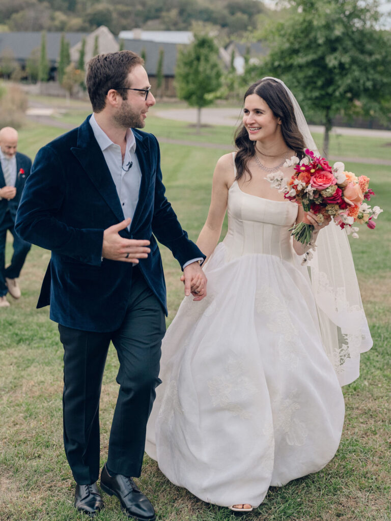 An autumnal, simple bridal bouquet displaying colors of burgundy, blush, rusty orange, and peach. Stunning florals include dahlias, garden roses, moab roses, cappuccino roses, brown ranunculus, zinnias, chocolate cosmos, brown sweet peas, toffee lisianthus, yarrow, marigolds and amaranthus. Beautiful fall florals for a wedding at Southall, TN. Design by Rosemary and Finch Floral Design in Nashville, TN.