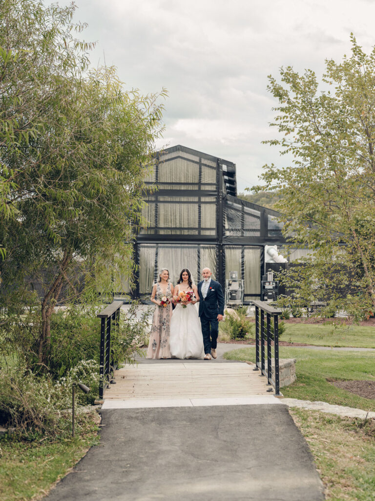 An autumnal, simple bridal bouquet displaying colors of burgundy, blush, rusty orange, and peach. Stunning florals include dahlias, garden roses, moab roses, cappuccino roses, brown ranunculus, zinnias, chocolate cosmos, brown sweet peas, toffee lisianthus, yarrow, marigolds and amaranthus. Beautiful fall florals for a wedding at Southall, TN. Design by Rosemary and Finch Floral Design in Nashville, TN.