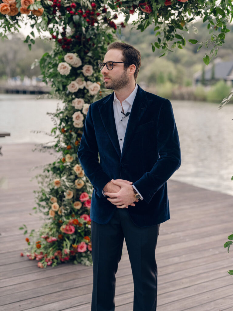 Stunning flower-forward, lush chuppah for fall wedding ceremony at Southall Farm and Inn. Bright, autumnal colors of rosy pink, deep red, blush, rusty orange, peach, and golden yellow are combined with the depth of full greenery. Color-blocked florals of dahlias, tess roses, cappuccino roses, moab roses, quicksand roses, spray roses, zinnias, lisianthus, yarrow, marigolds, ranunculus, and more cover the chuppah. Design by Rosemary and Finch Floral Design in Nashville, TN.
