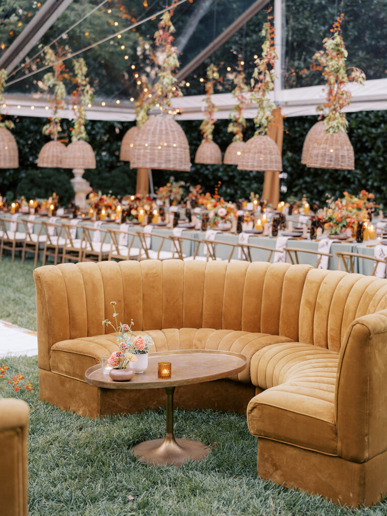 Gorgeous, flower-forward centerpiece arrangements for a private birthday party in Nashville, TN. Autumnal hues of red, brown, orange, pinks and cream are showcased in a stunning display of dahlias, zinnias, ranunculus, nigella, viburnum, rudbeckia, marigolds, liquid amber, spray roses, geranium, rose hips and bittersweet. Fall foliage provides greenery for arrangements and are wrapped around each tent pole and pendant. Design by Rosemary and Finch Floral Design in Nashville, TN. 