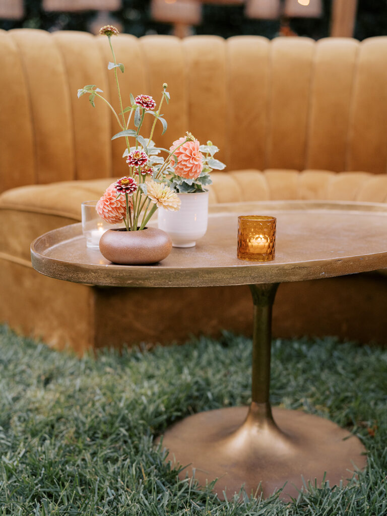 Stunning, autumnal ikebana centerpieces for a private birthday party in Nashville, TN. Each arrangement holds varying clusters of peach, burgundy and orange dahlias, spray roses, nigella, clematis pods, copper zinnias, red gem marigolds, salmon sweet peas, brown ranunculus, rose hips, explosion grass and lisianthus. Bright colors draw the eye to a beautiful table display surrounded by warm tea lights and woven pendants above. Design by Rosemary and Finch Floral Design in Nashville, TN. 