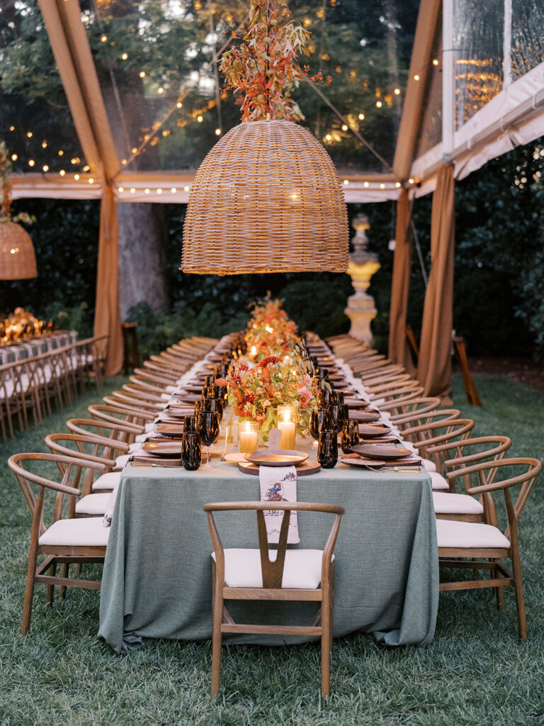 Gorgeous, flower-forward centerpiece arrangements for a private birthday party in Nashville, TN. Autumnal hues of red, brown, orange, pinks and cream are showcased in a stunning display of dahlias, zinnias, ranunculus, nigella, viburnum, rudbeckia, marigolds, liquid amber, spray roses, geranium, rose hips and bittersweet. Fall foliage provides greenery for arrangements and are wrapped around each tent pole and pendant. Design by Rosemary and Finch Floral Design in Nashville, TN. 