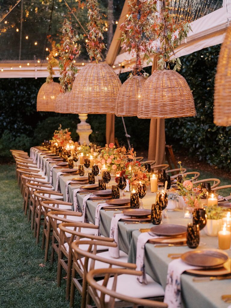 Gorgeous, flower-forward centerpiece arrangements for a private birthday party in Nashville, TN. Autumnal hues of red, brown, orange, pinks and cream are showcased in a stunning display of dahlias, zinnias, ranunculus, nigella, viburnum, rudbeckia, marigolds, liquid amber, spray roses, geranium, rose hips and bittersweet. Fall foliage provides greenery for arrangements and are wrapped around each tent pole and pendant. Design by Rosemary and Finch Floral Design in Nashville, TN. 