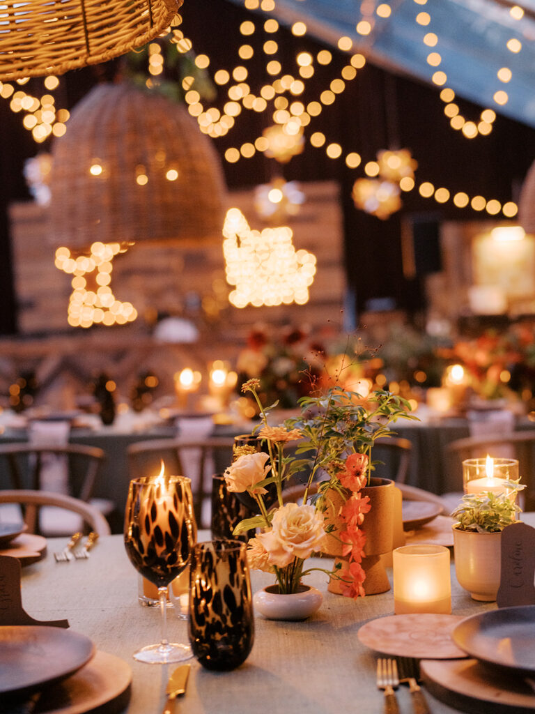 Stunning, autumnal ikebana centerpieces for a private birthday party in Nashville, TN. Each arrangement holds varying clusters of peach, burgundy and orange dahlias, spray roses, nigella, clematis pods, copper zinnias, red gem marigolds, salmon sweet peas, brown ranunculus, rose hips, explosion grass and lisianthus. Bright colors draw the eye to a beautiful table display surrounded by warm tea lights and woven pendants above. Design by Rosemary and Finch Floral Design in Nashville, TN. 